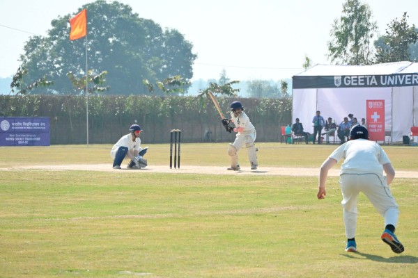 Students playing cricket